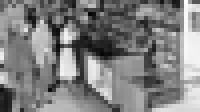 Black-and-white image of customers at a music store listening to vinyl records. Black-and-white image of customers at a music store listening to vinyl records.